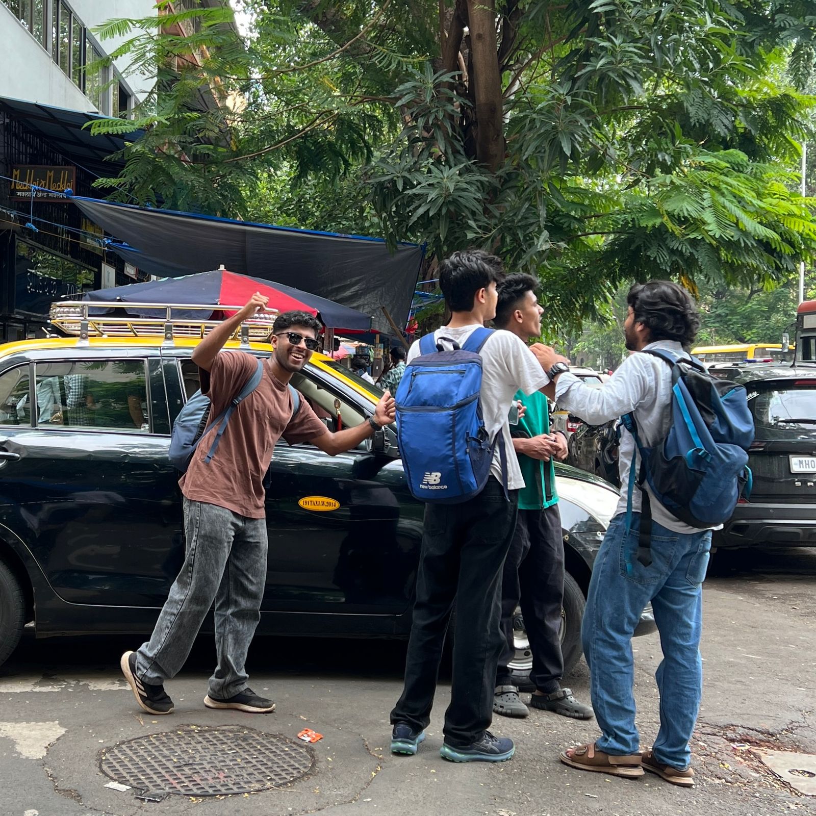 Friends around black taxi on city street